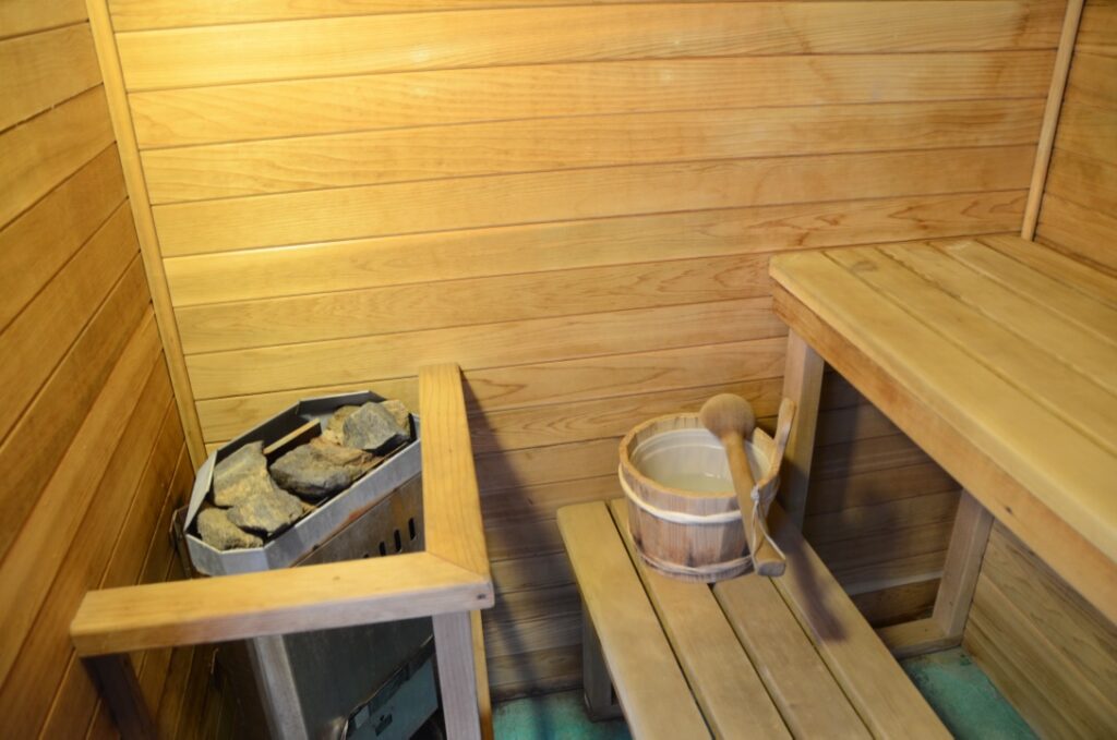 Inside the Spaah sauna: wood-lined walls, benches, and a heater with hot stones